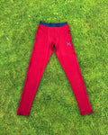 Red leggings with a logo on a grassy background