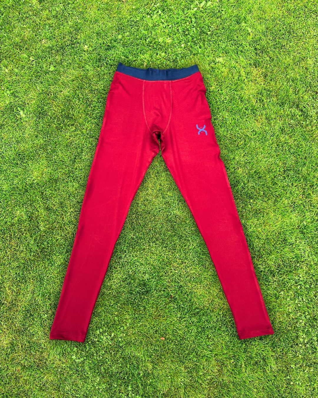 Red leggings with a logo on a grassy background